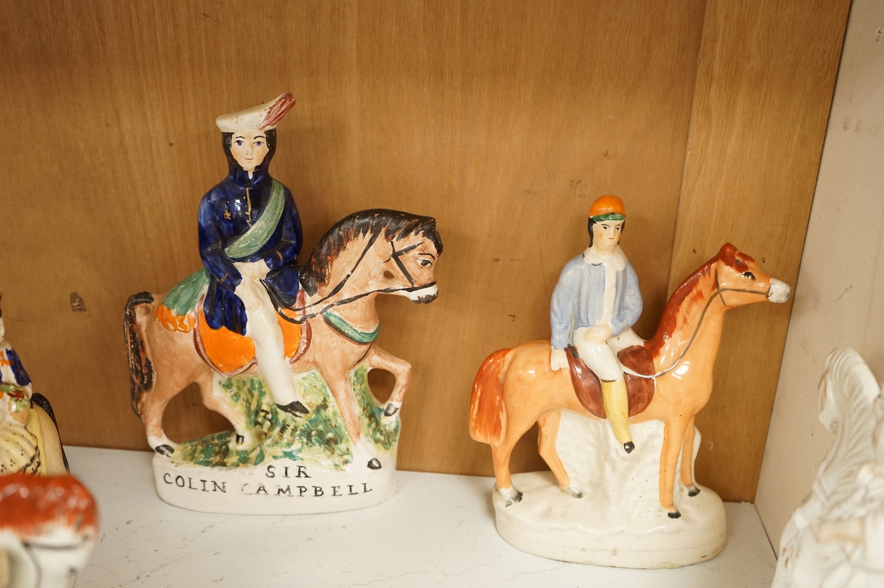 Thirteen Staffordshire pottery equestrian figures to include Tom King, Dick Turpin and Sir Colin Campbell, largest 28cm high